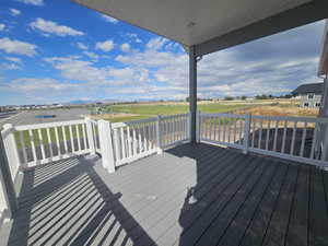 Wooden terrace featuring a yard and a playground