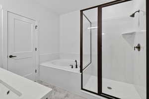 Full bath with a stall shower, a bath, vanity, and light marble finish flooring