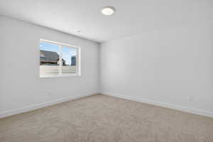 Empty room featuring carpet floors and baseboards