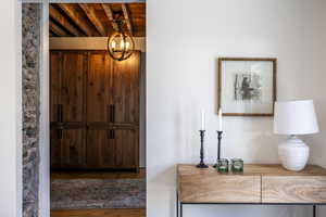 Foyer entrance featuring wood finished floors, a chandelier, and wood ceiling