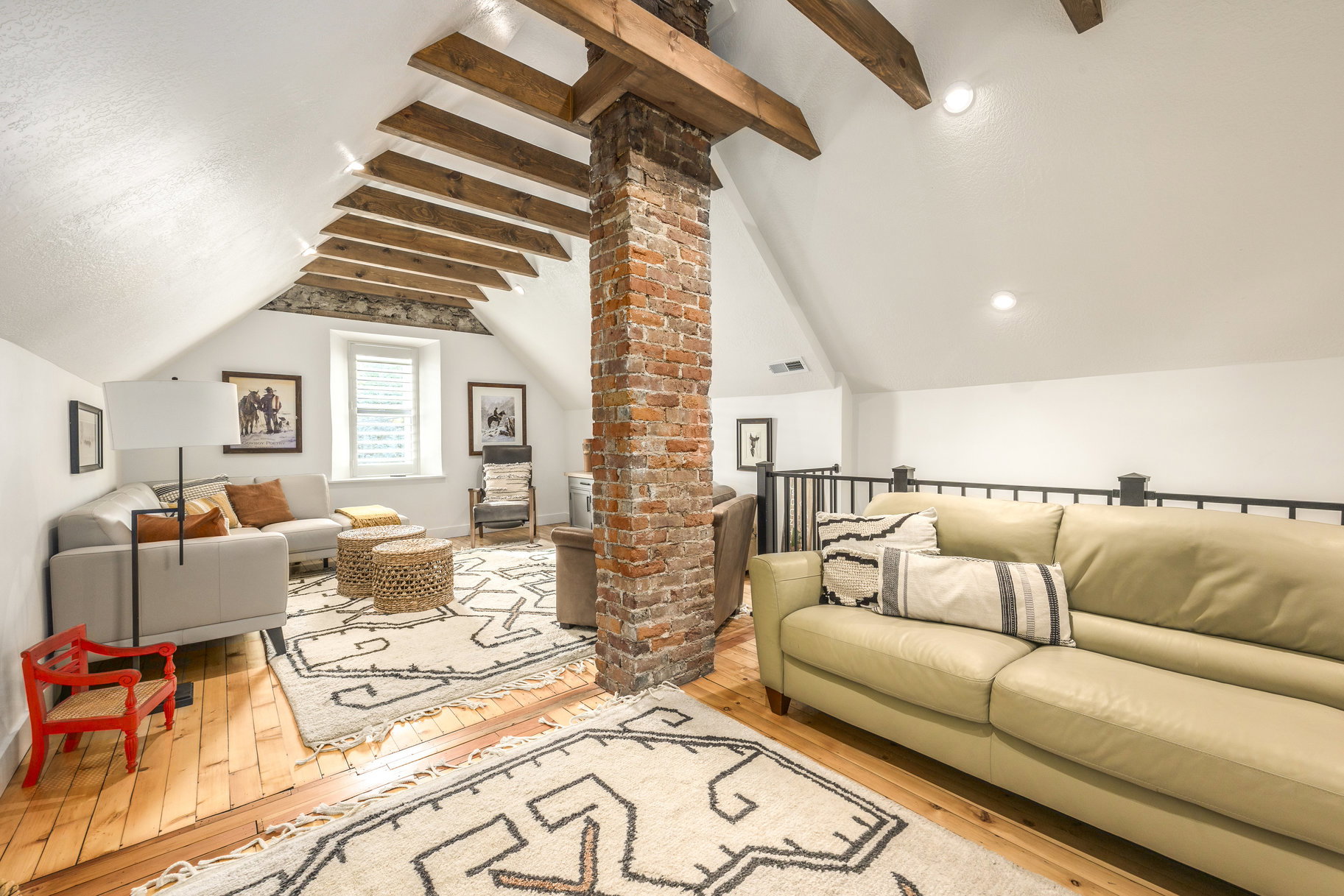 Living area with hardwood / wood-style floors and decorative columns