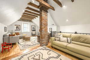 Living area with hardwood / wood-style floors and decorative columns