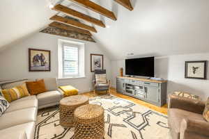 Living area featuring light wood-type flooring and baseboards