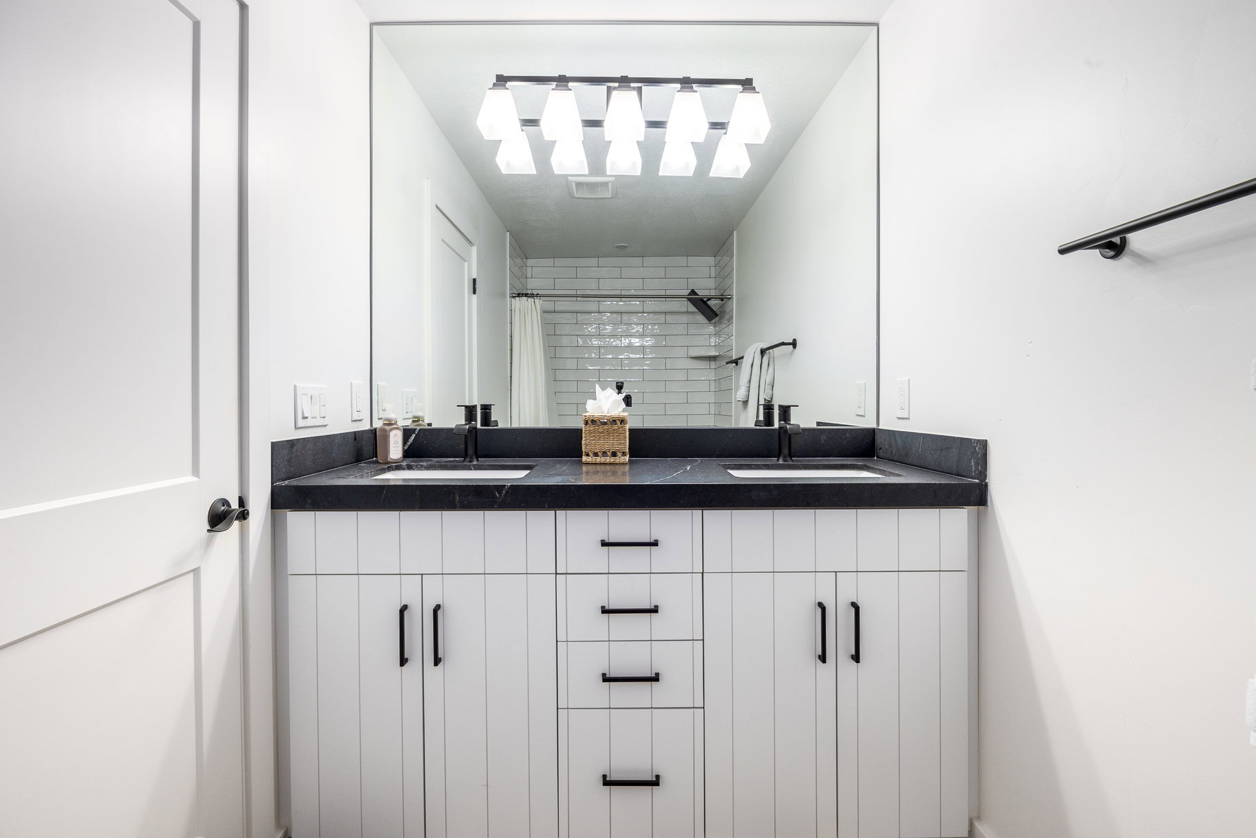 Bathroom with double vanity and a shower with shower curtain