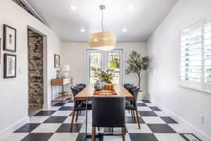 Dining room featuring dark floors and recessed lighting