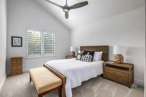 Bedroom featuring lofted ceiling, light carpet, and ceiling fan