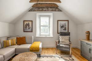 Sitting room featuring light wood-style flooring and baseboards