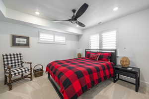 Bedroom with light carpet, ceiling fan, recessed lighting, and a textured ceiling