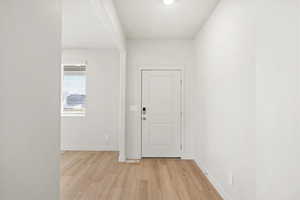 Entrance foyer featuring light wood-type flooring and baseboards