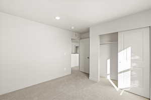 Unfurnished bedroom featuring carpet and a closet