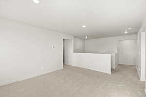Empty room featuring light colored carpet and recessed lighting