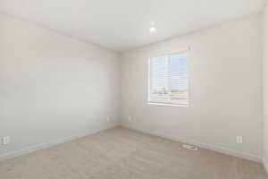 Unfurnished room featuring light carpet and recessed lighting