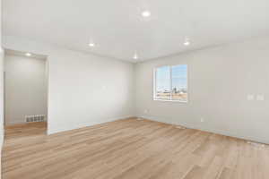 Unfurnished room with light wood-type flooring and recessed lighting
