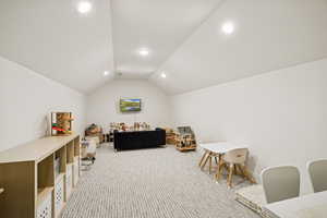 Recreation room with vaulted ceiling, light carpet, and recessed lighting