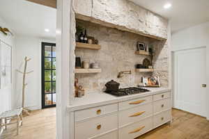 Kitchen featuring open shelves, white cabinets, light wood-style flooring, decorative backsplash, and recessed lighting