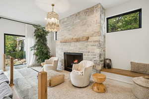 Living area with a fireplace and a chandelier