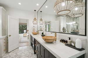 Ensuite bathroom with double vanity and recessed lighting