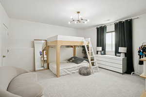 Bedroom featuring carpet floors and a chandelier