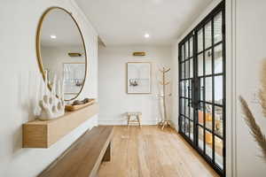 Doorway to outside featuring hardwood / wood-style flooring and recessed lighting