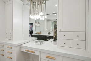 Bathroom with vanity, recessed lighting, and a walk in closet