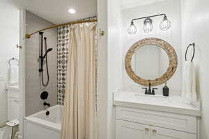 Full bathroom featuring vanity and shower / bath combo with shower curtain