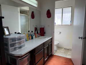 Bathroom with vanity, a stall shower, and light carpet