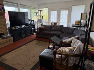Living room with carpet floors, a textured ceiling, plenty of natural light, and french doors
