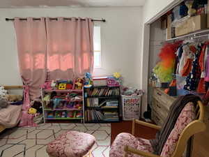 Playroom with a textured ceiling and carpet floors