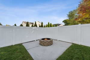 Fenced backyard featuring a patio and an outdoor fire pit