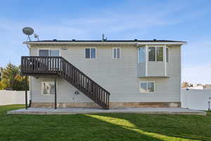 Rear view of house featuring a patio area, a fenced backyard, stairs, a deck, and a gate