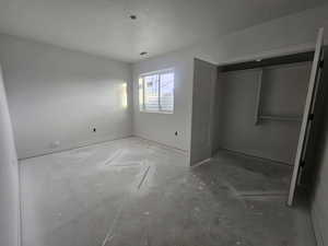 Unfurnished bedroom with a closet and a textured ceiling