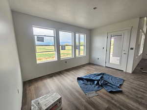 Interior space with a textured ceiling and wood finished floors