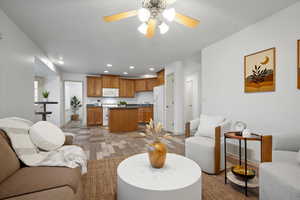 Living room with recessed lighting and a ceiling fan