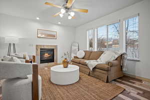 Living area featuring a tile fireplace, wood finished floors, recessed lighting, and ceiling fan