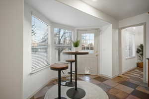 Foyer featuring healthy amount of natural light and stone tile floors