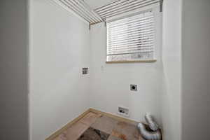 Washroom with hookup for a washing machine and electric dryer hookup