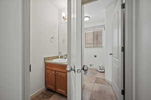 Bathroom with vanity and baseboards