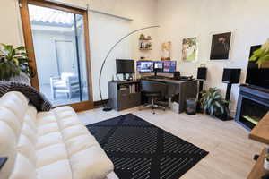 Office with a glass covered fireplace