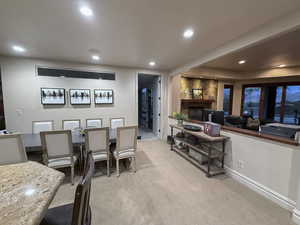 Dining space featuring light colored carpet and recessed lighting