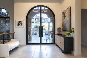 Entrance foyer featuring light tile patterned floors