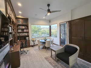 Home office with recessed lighting, a ceiling fan, light carpet, and built in desk