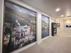 Hall featuring baseboards and carpet flooring
