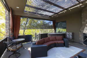 View of patio / terrace featuring a pergola, outdoor lounge area, and a hot tub