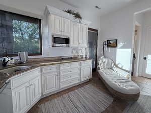Bathroom with vanity and dark tile patterned flooring