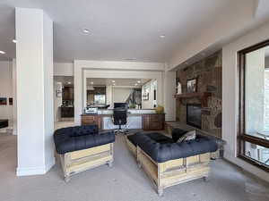 Living area featuring light carpet, a fireplace, recessed lighting, and an office area