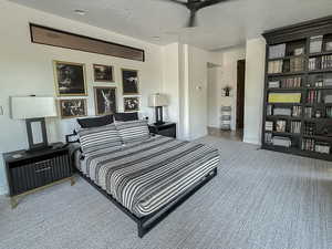 Carpeted bedroom with baseboards and a textured ceiling