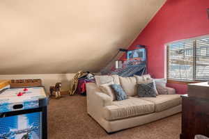 Bedroom featuring vaulted ceiling and carpet floors