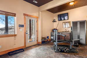 Entryway with baseboards and stone tile floors