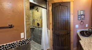 Full bathroom featuring vanity and a shower stall