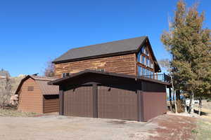 Garage with dirt driveway
